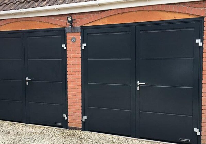 Pair of side-hinged garage doors with a matching pedestrian door